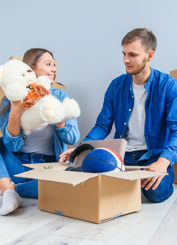 young-couple-unpacking-things-after-moving-into-new-house 1